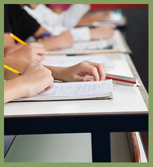 Students writing in the notebooks